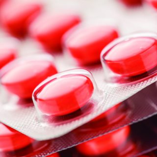 Colourful tablets in plastic packing as background