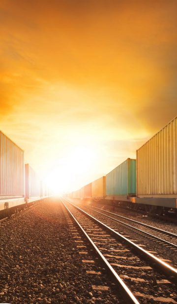 industry container trainst running on railways track against beautiful sun set sky use for land transport and logistic business