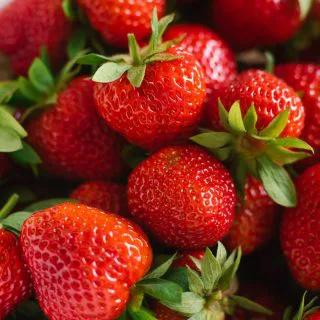 Fresh red organic strawberries closeup, background of berries