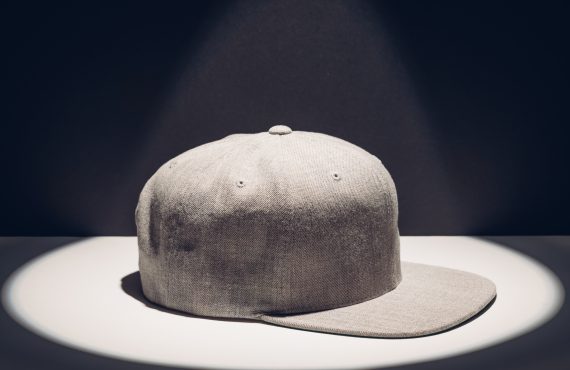 gray baseball cap in a round spot of light